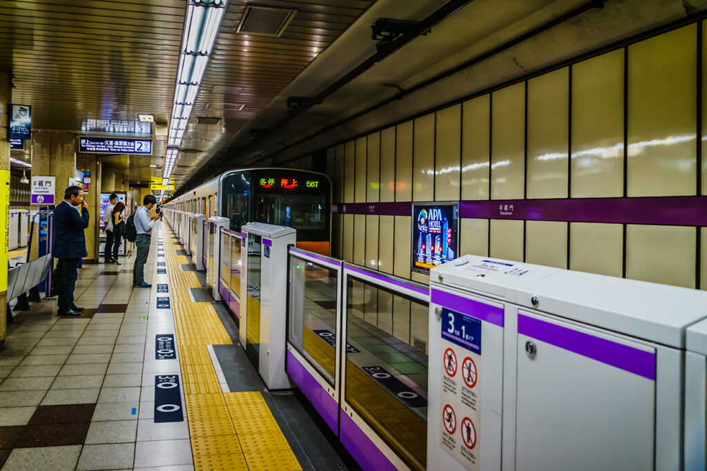 Tokyo, Japan - May 11, 2019: Passengers waiting for their train at subway underground station. Travelling by Tokyo metro.